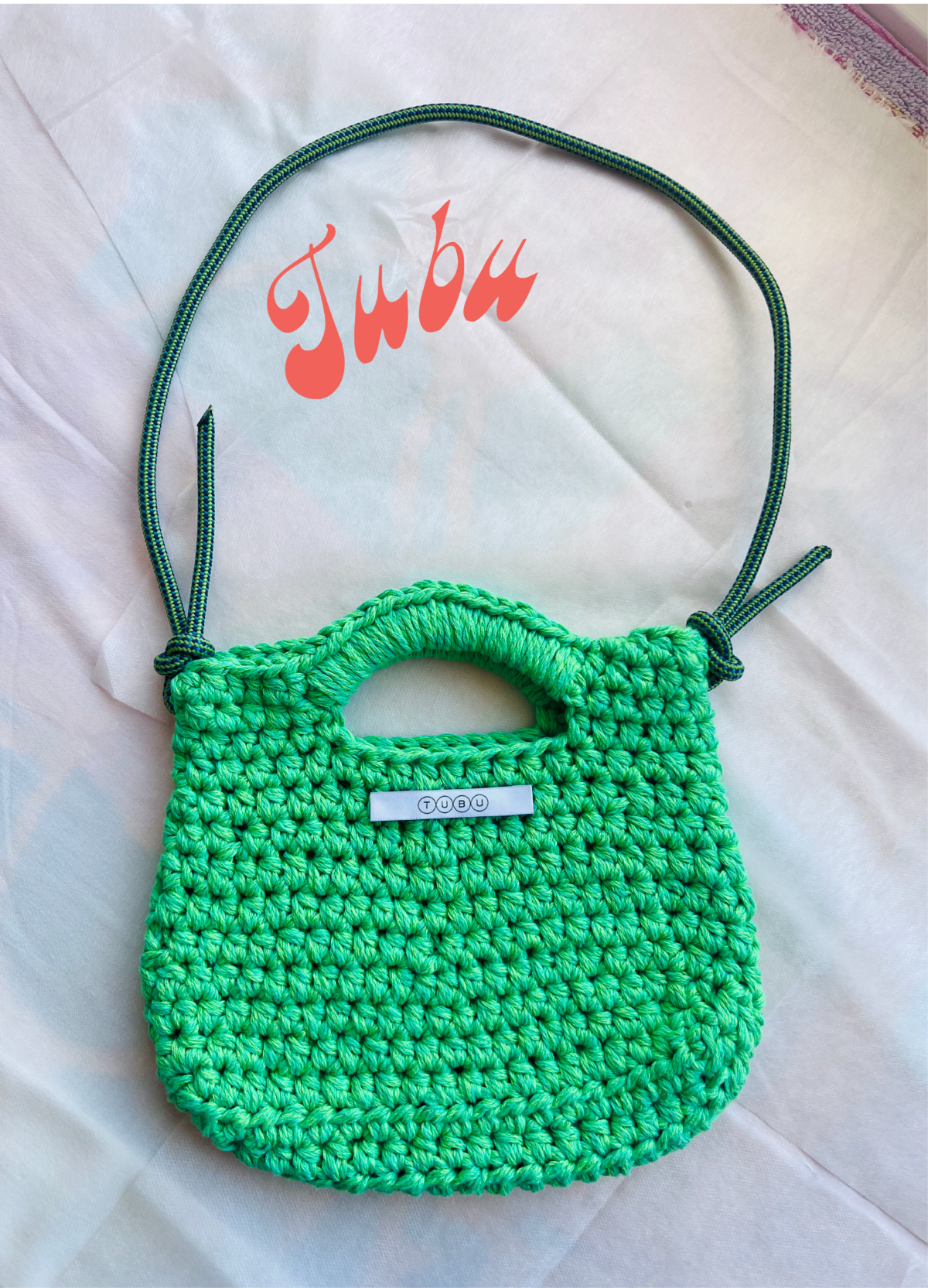 An acidic green crocheted bag with a drawstring made of discarded climbing rope.